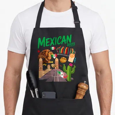Tablier de cuisine noir avec illustration mexicaine incluant aigle, pyramide, serape et cactus fleurissant.