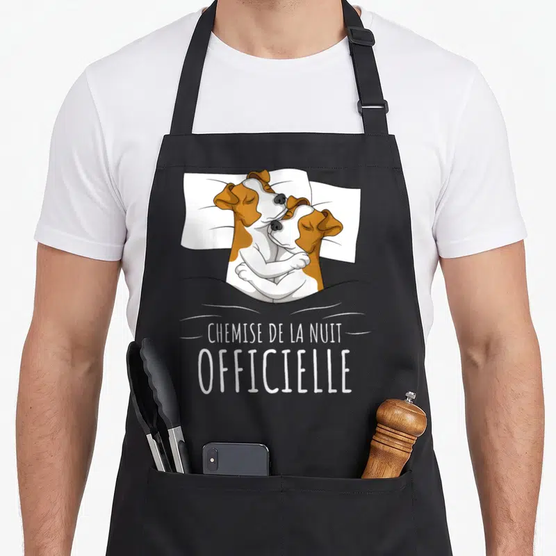 Tablier de cuisine noir avec deux chiens Jack Russel s'enlaçant sous une couverture et le texte « chemise de la nuit » imprimé en blanc.