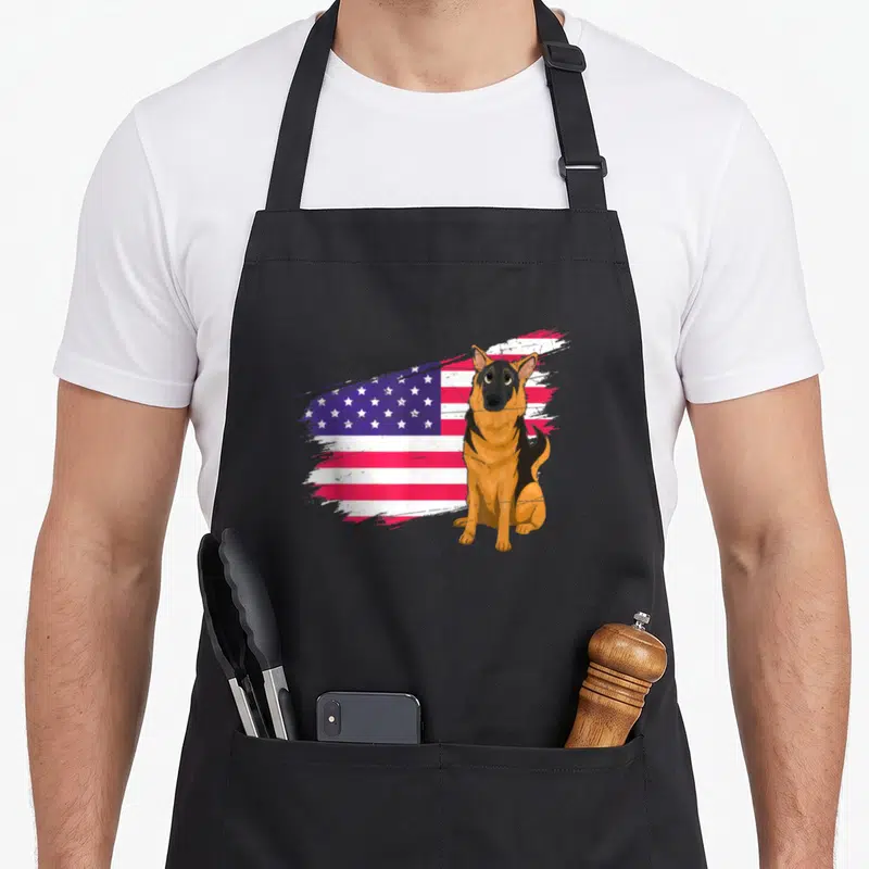 Tablier de cuisine noir avec illustration d'un Berger Allemand et drapeau USA en arrière-plan stylisé.