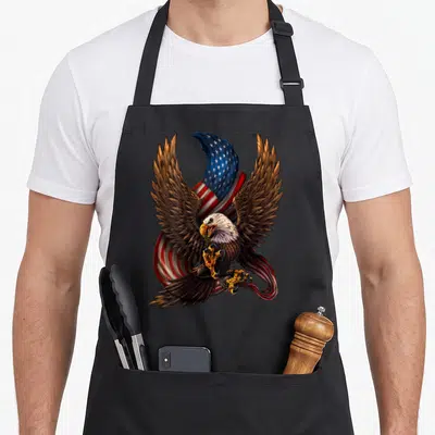Tablier de cuisine noir avec aigle aux ailes déployées et drapeau américain en arrière-plan.