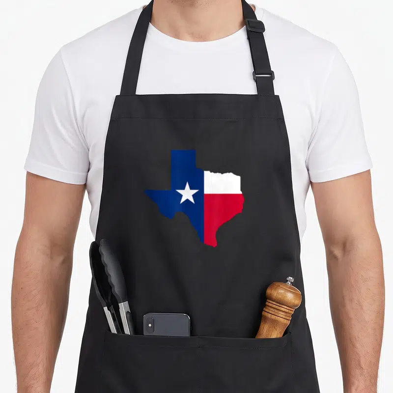 Tablier de cuisine noir avec silhouette du Texas arborant les couleurs du drapeau Lone Star.