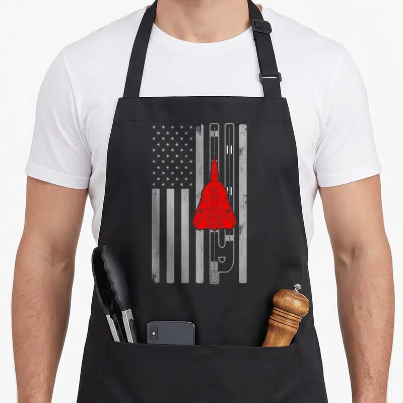 Tablier de cuisine noir avec avion F-14 Tomcat rouge sur drapeau américain en gris et blanc.