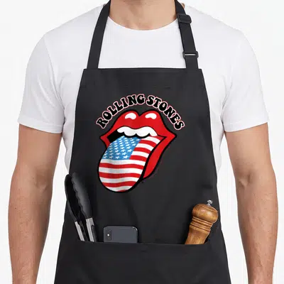 Tablier de cuisine noir avec une bouche rouge et une langue aux étoiles et bandes du drapeau américain.