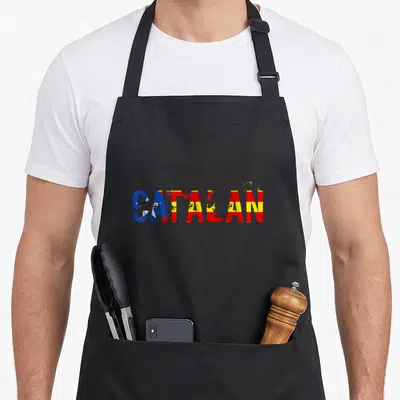 Tablier de cuisine noir avec le mot catalan aux couleurs du drapeau estelada en typographie dégradée.