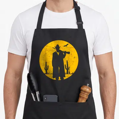 Tablier de cuisine noir avec silhouette cowboy sunset vintage et cactus wild western orange