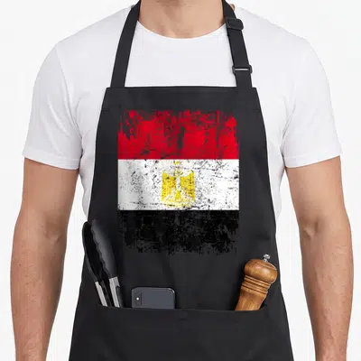 Tablier de cuisine noir avec le drapeau de l'Égypte en rouge blanc noir et l'aigle doré central.