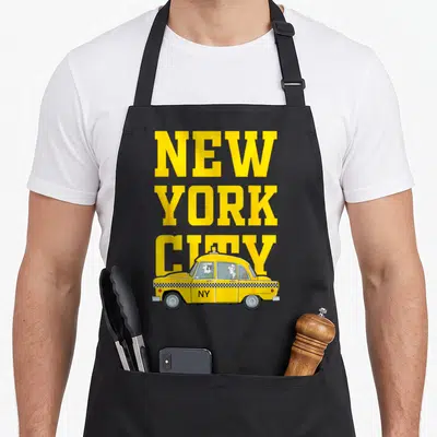 Tablier de cuisine noir avec inscription New York City et illustration de taxi jaune classique.