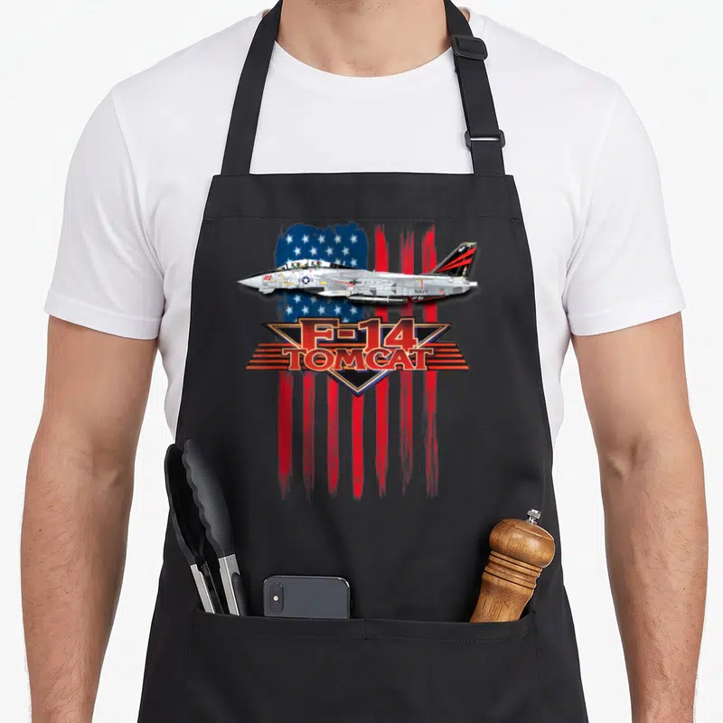 Tablier de cuisine noir avec illustration d'un F-14 Tomcat sur fond de drapeau américain stylisé.