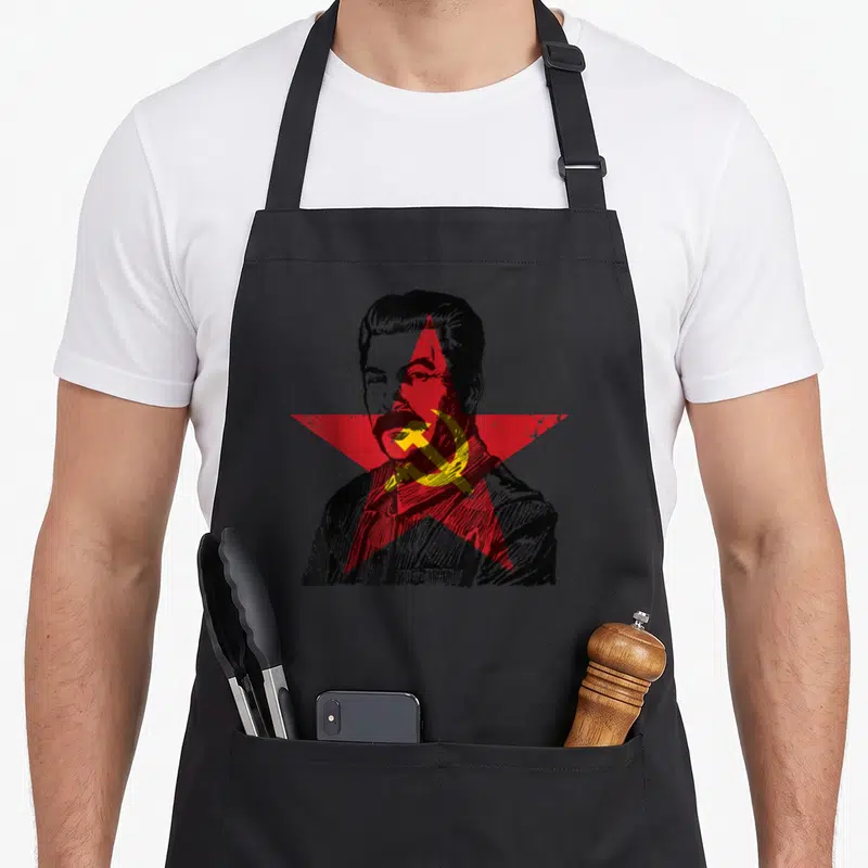 Tablier de cuisine noir avec portrait gravé de Josef Stalin, étoile rouge et faucille marteau jaune sur le visage.
