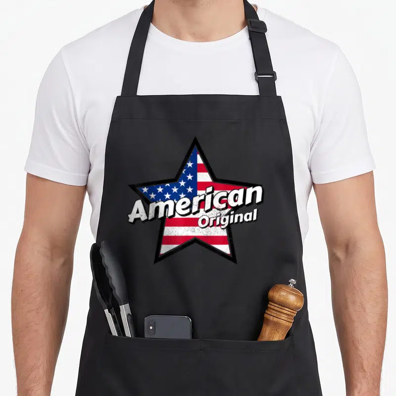 Tablier de cuisine noir avec une grande étoile aux couleurs du drapeau américain et le texte American Original en blanc.