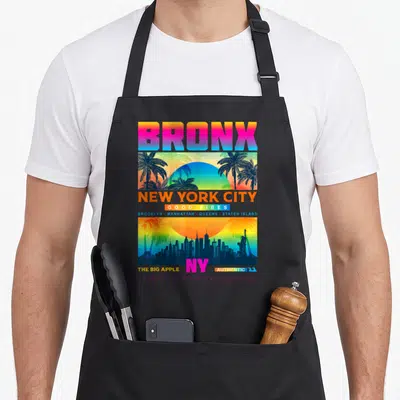 Tablier de cuisine noir avec un motif coloré représentant le Bronx et le skyline de New York City au coucher du soleil.