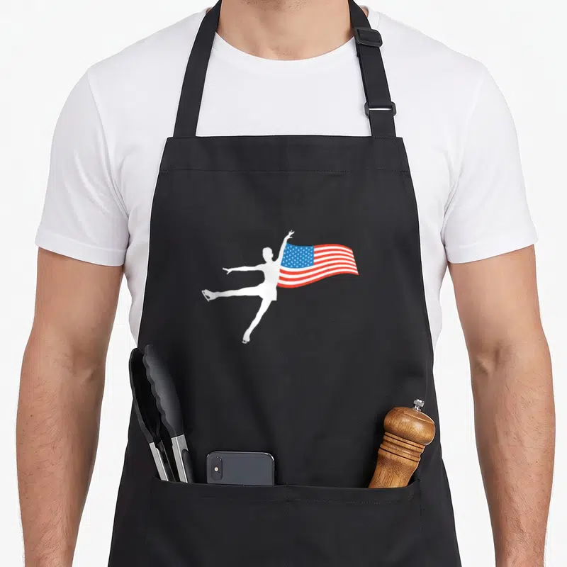 Tablier de cuisine noir avec silhouette blanche de patineur tenant un drapeau américain ondulé.