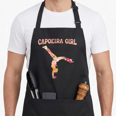 Tablier de cuisine noir avec une silhouette fleurie en acrobatie et l'inscription Capoiera Girl en rose