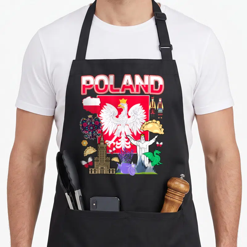 Tablier de cuisine noir avec illustration colorée de l'aigle polonais, des pierogi et le mot POLAND en lettres rouges et blanches.