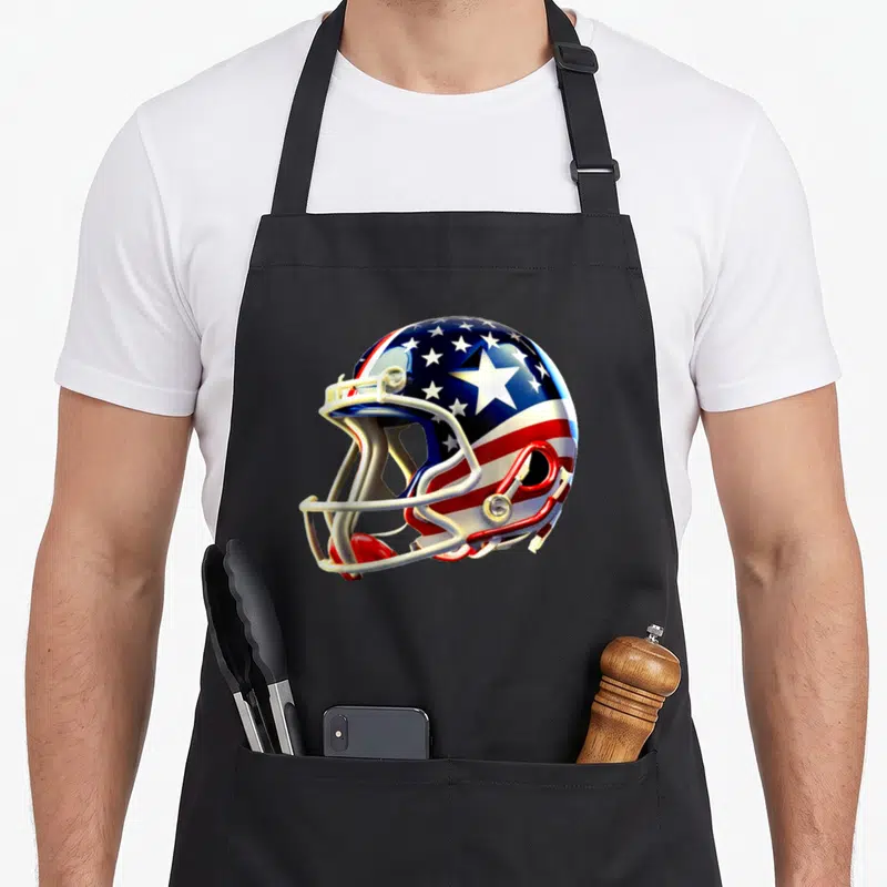 Tablier de cuisine noir avec un casque de football américain décoré des étoiles et bandes du drapeau américain.
