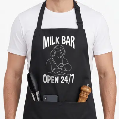 Tablier de cuisine noir avec illustration blanche d'une maman allaitant et le texte Milk Bar Open 24/7.