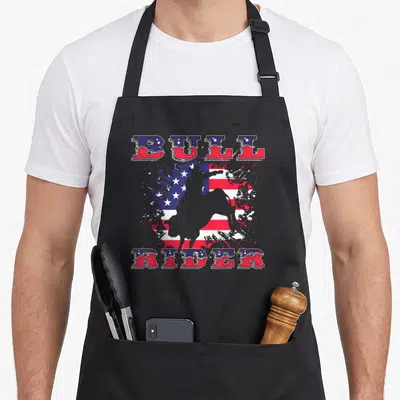 Tablier de cuisine noir avec illustration Bull Rider et drapeau américain aux éclats de peinture.