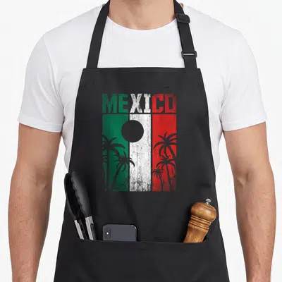 Tablier de cuisine noir avec linscription Mexico et un drapeau vert blanc rouge surmonté de palmiers gris stylisés.