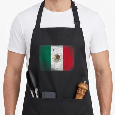 Tablier de cuisine noir avec le drapeau mexicain texturé et l'aigle au centre.