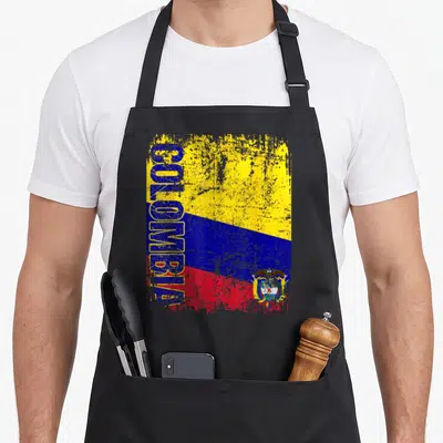 Tablier de cuisine noir avec drapeau Colombie vertical, inscription COLOMBIE et armoiries en style dégradé.