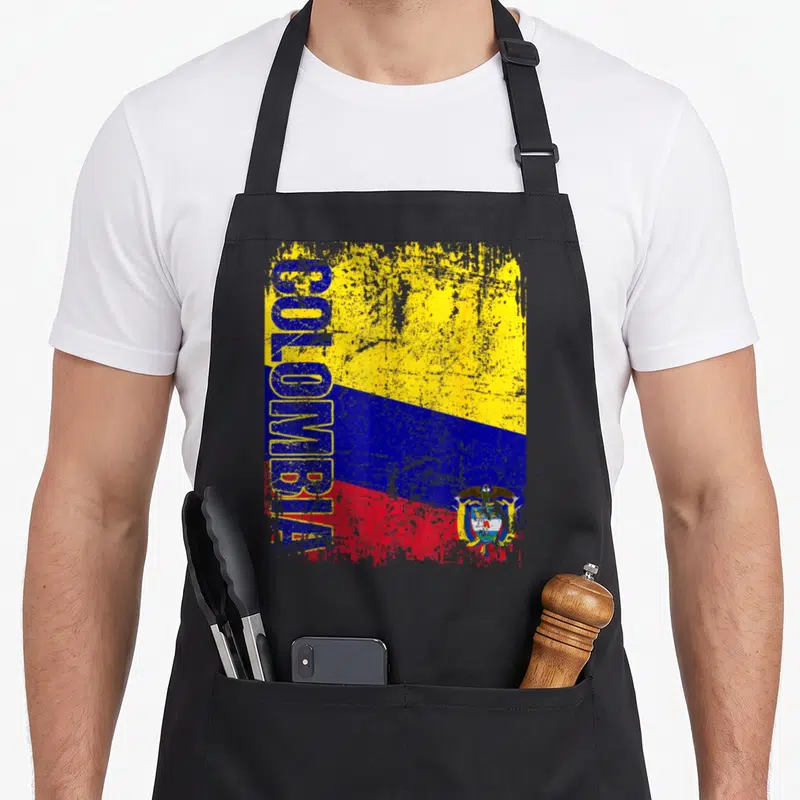 Tablier de cuisine noir avec drapeau Colombie vertical, inscription COLOMBIE et armoiries en style dégradé.