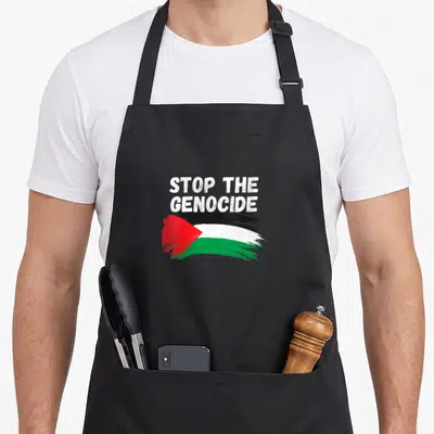 Tablier de cuisine noir avec inscription Stop The Genocide et drapeau palestinien aux couleurs vives.