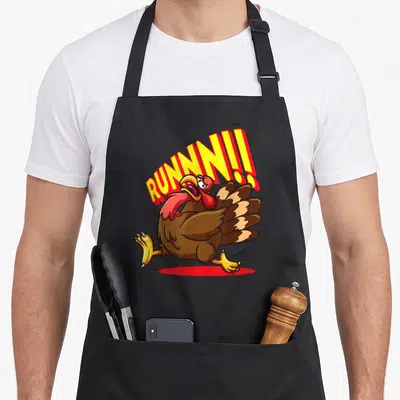 Tablier de cuisine noir avec une dinde cartoon fuyante et le mot RUNNN. en lettres jaunes et rouges.