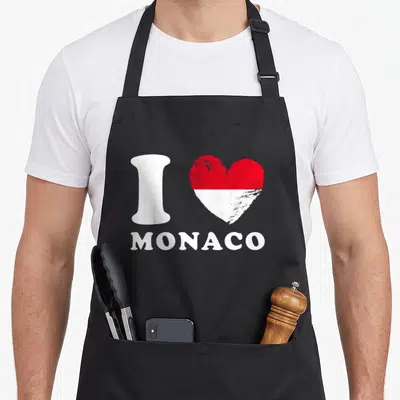 Tablier de cuisine noir avec le texte I Love Monaco et un cœur bicolore rouge et blanc imitant le drapeau national.