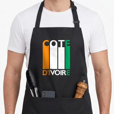 Tablier de cuisine noir avec typographie COTE D'IVOIRE aux couleurs orange blanc et vert du drapeau national.