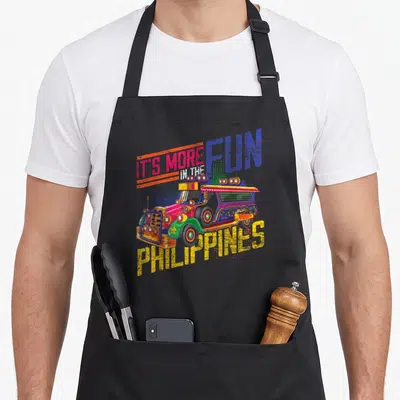 Tablier de cuisine noir avec illustration d'un jeepney philippin coloré et le texte It's more fun in the Philippines.