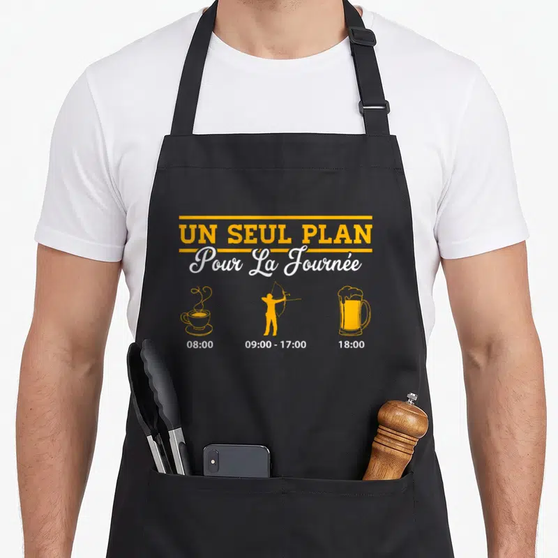 Tablier de cuisine noir avec un seul plan pour la journée et silhouettes orange.