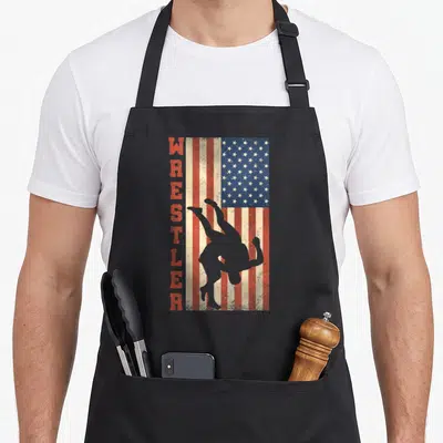 Tablier de cuisine noir avec drapeau américain vintage et silhouette de lutteur verticalement aligné.