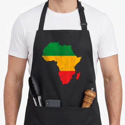 Tablier de cuisine noir avec la carte de l'Afrique aux couleurs vert jaune et rouge en bandes horizontales.