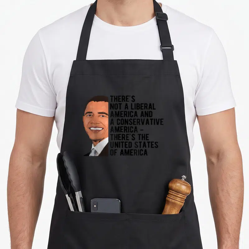 Tablier de cuisine noir avec portrait stylisé et texte blanc citant l'United States of America