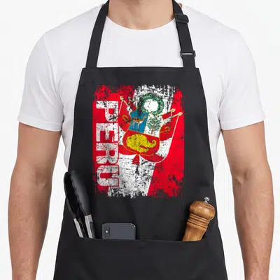 Tablier de cuisine noir avec inscription PEROU et armoiries sur fond de drapeau rouge et blanc texturé.