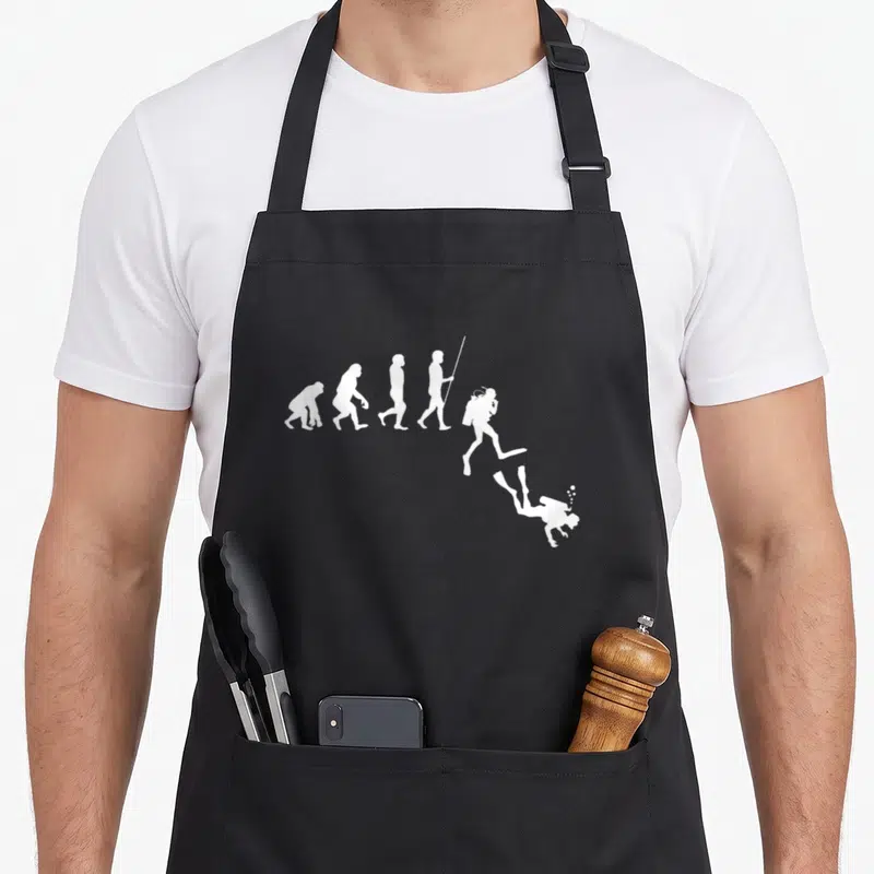 Tablier de cuisine noir avec silhouette blanche montrant l'évolution humaine vers la plongée sous-marine.