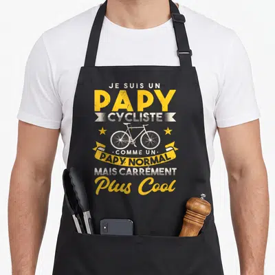 Tablier de cuisine noir avec texte Je suis un papy cycliste et dessin de bicyclette jaune et blanc sur fond uni.