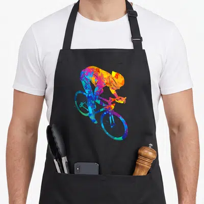 Tablier de cuisine noir avec illustration d'un cycliste en course aux couleurs vives et éclaboussées.