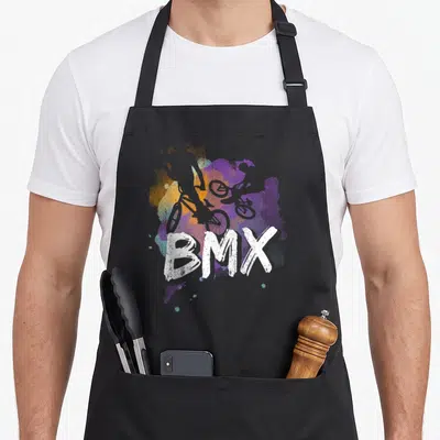 Tablier de cuisine noir avec une illustration colorée représentant un cycliste BMX et le mot BMX en blanc.