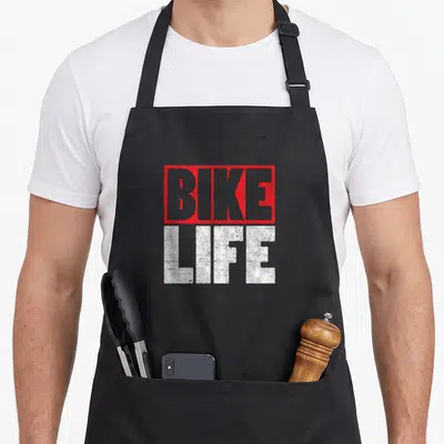Tablier de cuisine noir avec inscription BIKE LIFE en lettres rouges et blanches style graffiti.
