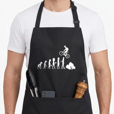 Tablier de cuisine noir avec silhouette blanche montrant l'évolution humaine terminant par un cycliste sur obstacle.