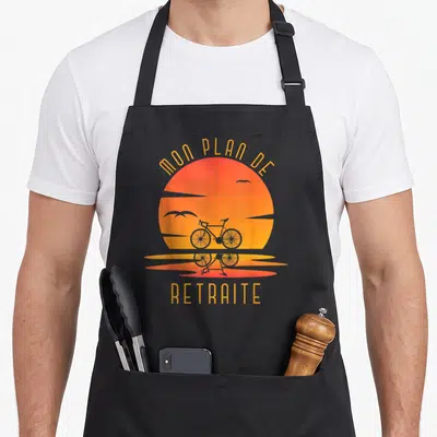 Tablier de cuisine noir avec illustration d'un soleil orange, d'une bicyclette et du texte Mon plan de retraite.