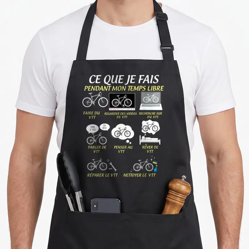 Tablier de cuisine noir avec illustration blanche et jaune représentant un VTT et des activités de cyclisme.