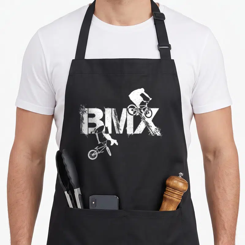 Tablier de cuisine noir avec l'inscription BIMIX et deux silhouettes blanches de cyclistes en acrobatie.
