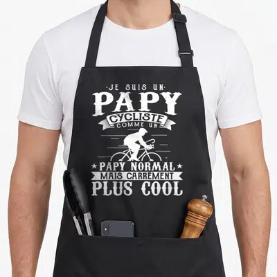Tablier de cuisine noir avec silhouette cycliste blanche et texte Je suis un papy cycliste comme un papy normal mais carrément plus cool