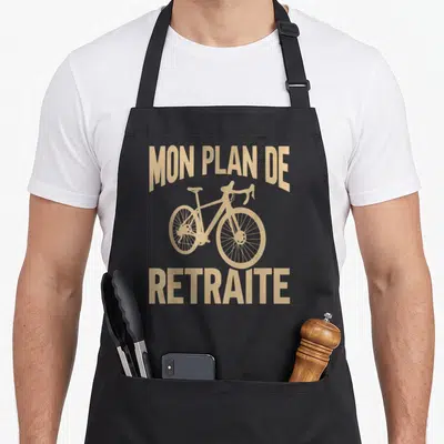 Tablier de cuisine noir avec illustration d'une bicyclette et le texte Mon Plan De Retraite Cycliste Route imprimé en beige.