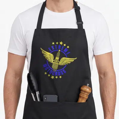 Tablier de cuisine noir avec une bougie ailée jaune et le texte Extreme Motocross en bleu.
