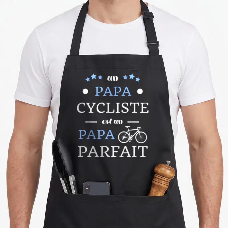 Tablier de cuisine noir avec l'inscription Papa cycliste est un papa parfait et une illustration de vélo.