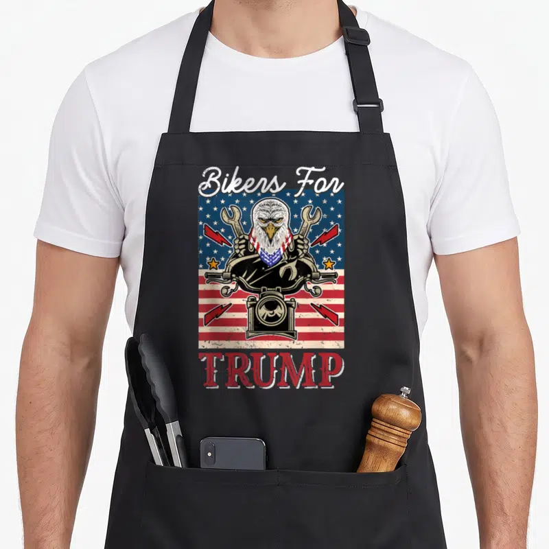 Tablier de cuisine noir avec un aigle tenant des clés et linscription TRUMP en rouge.