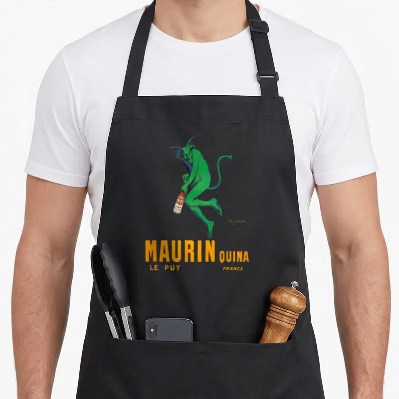 Tablier de cuisine noir avec démon vert tenant une bouteille Maurin Quina et texte orange